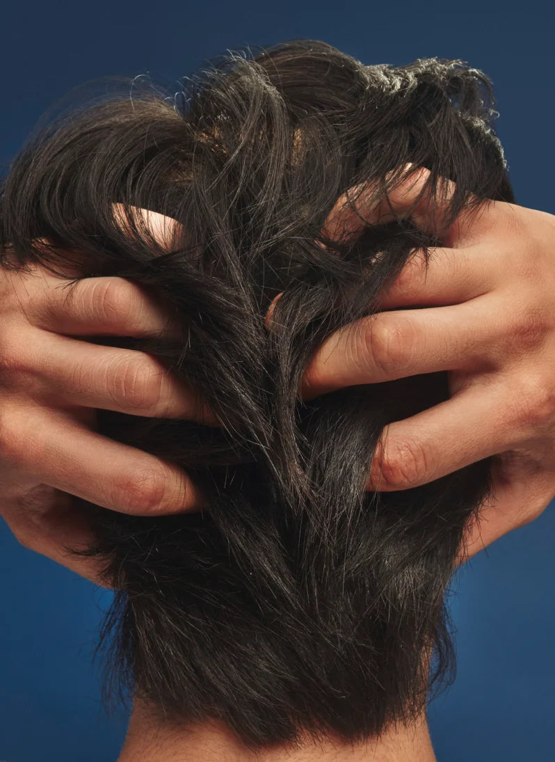 Person running hands through thick hair